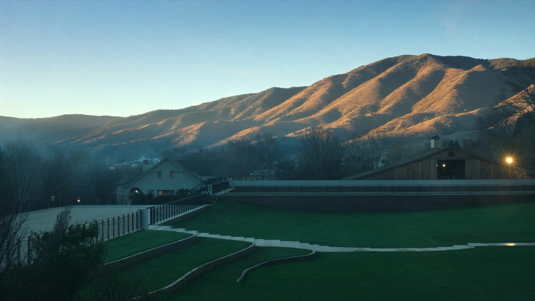 Golden-hour light on the mountain ridges above Agoura Hills homes and horse-property barns