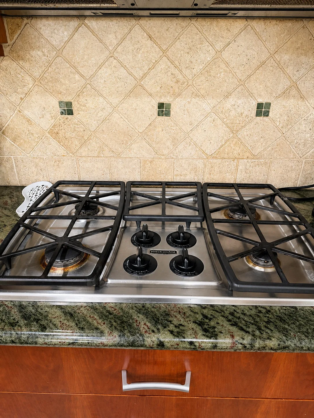 Stainless steel gas cooktop with grates and burners