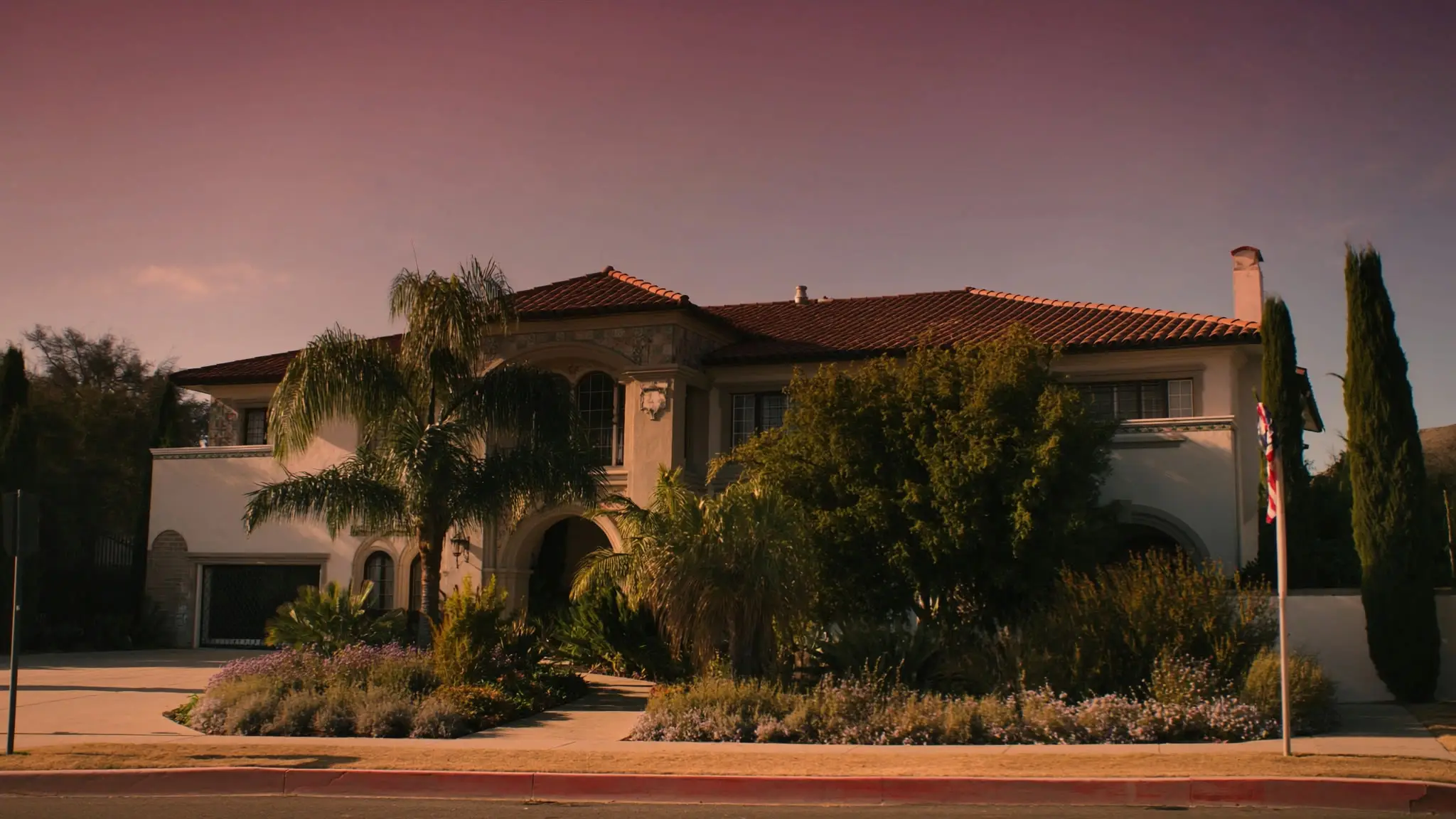Mediterranean tile-roofed Culver City home with palms and cypress under a pink dusk sky