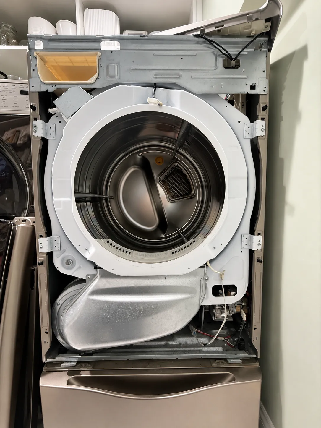 Front load dryer with the door ring removed, exposing the drum during service