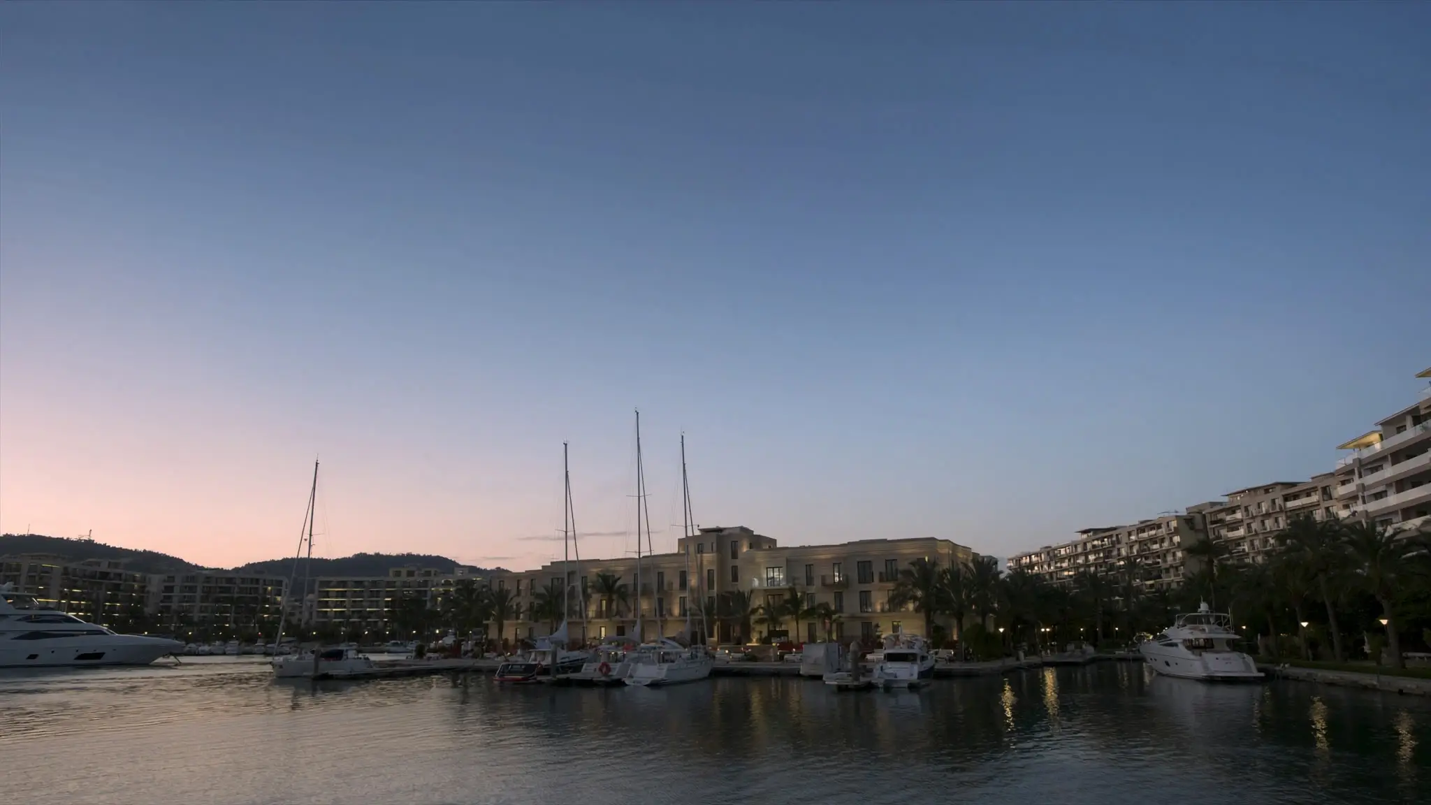 Sailboats and yachts moored at dusk in Marina del Rey's harbor