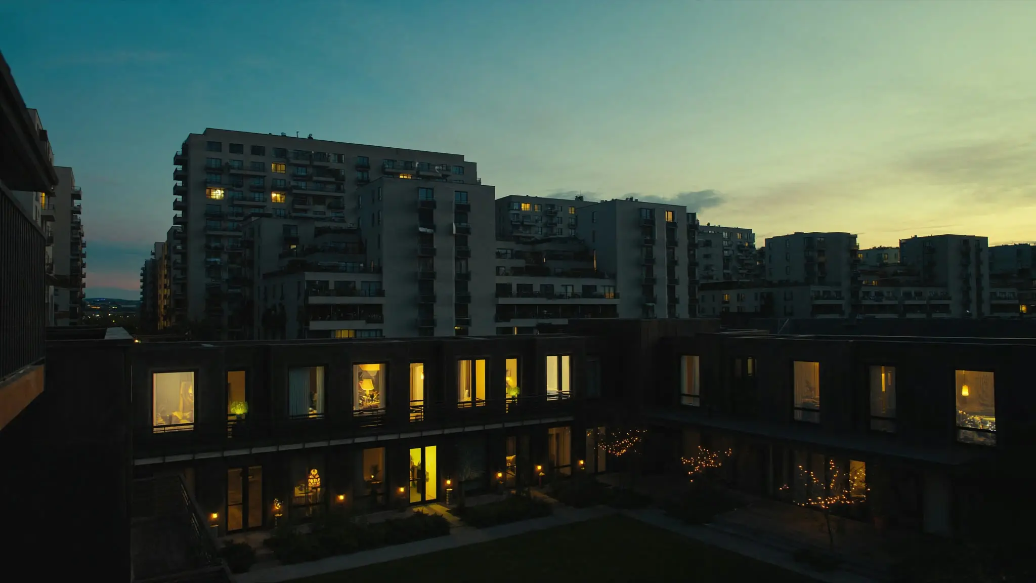Modern Playa Vista apartment blocks at dusk with a courtyard strung with lights