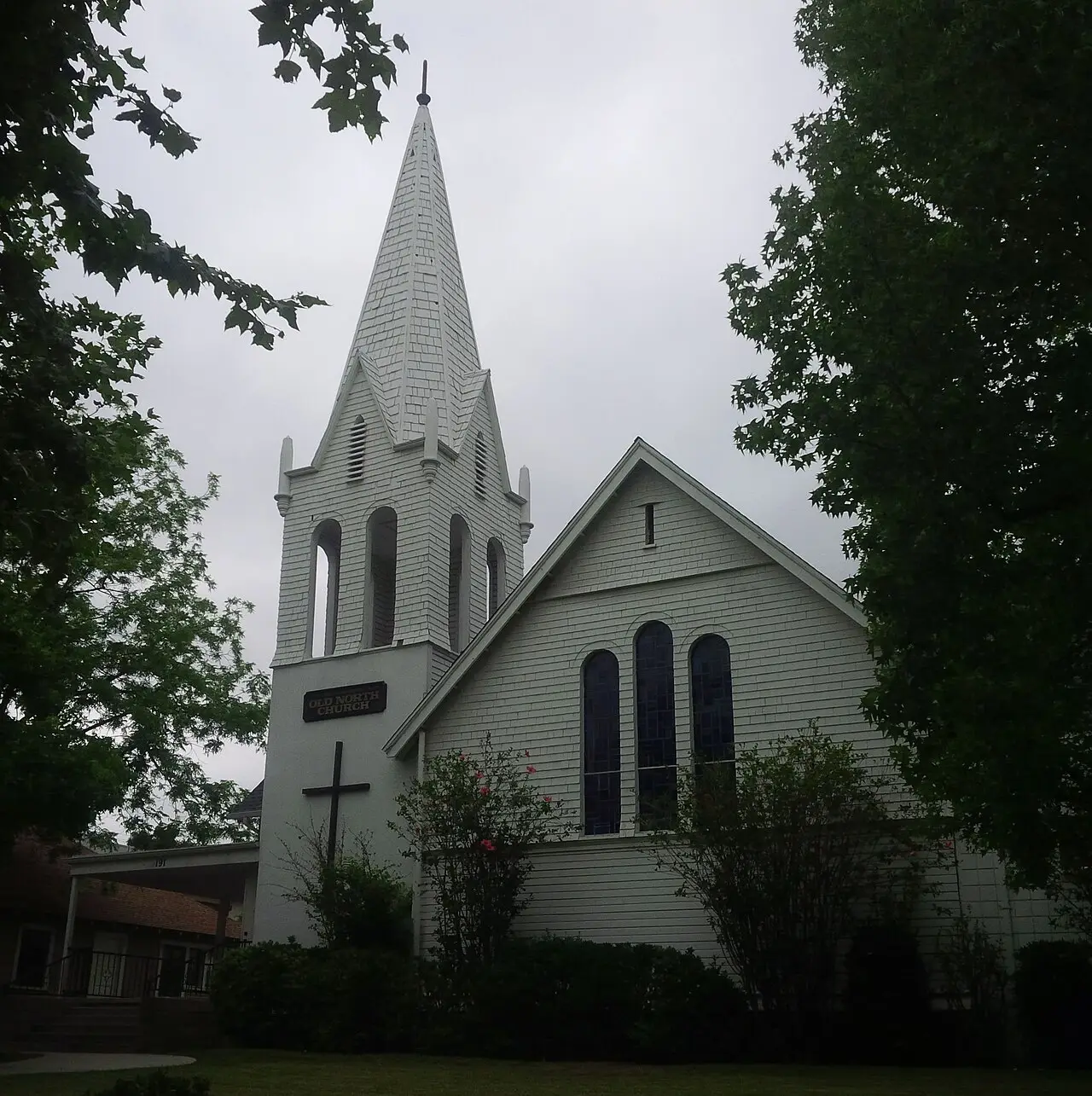 White steepled church framed by trees in Sierra Madre