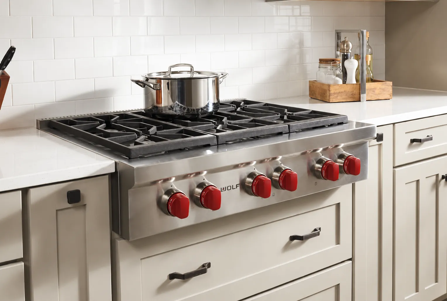 Wolf gas rangetop with signature red knobs and cast iron grates