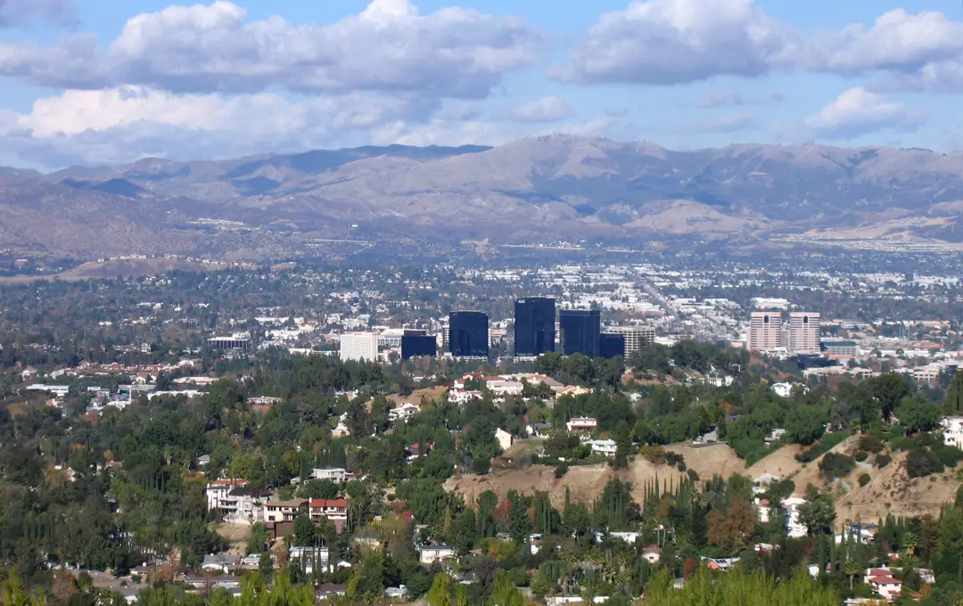 Woodland Hills' leafy hills with the Warner Center towers, valley and mountains beyond